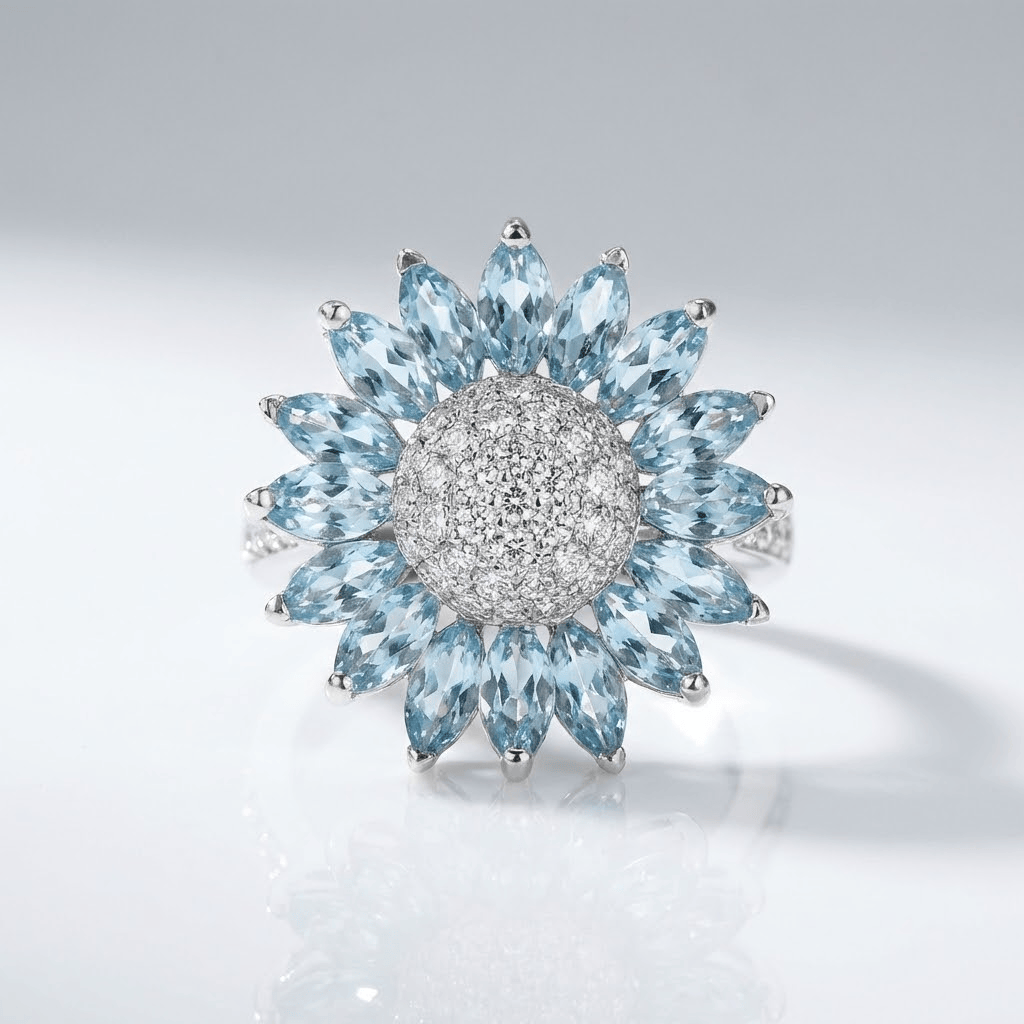 Silberner Ring mit blauem Topas in Blumenform, von der Marke Rose & Oliver, mit feinen Details und glänzenden Steinen.