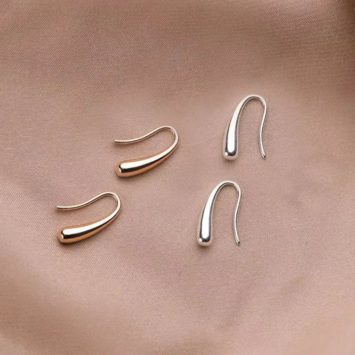 Aretes de drop vintage en oro y plata de Rose & Oliver, con diseño creativo y detalles elegantes.